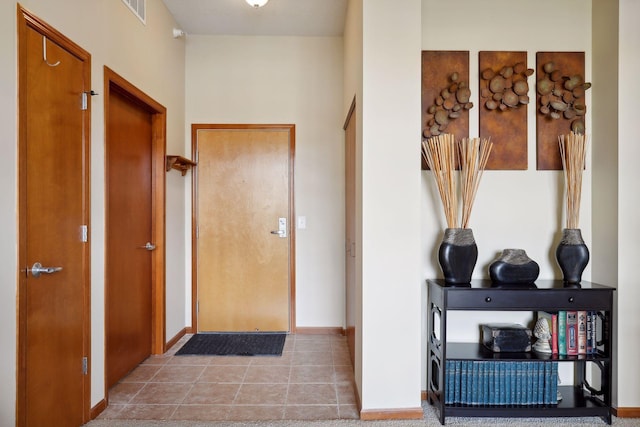 corridor with light tile patterned flooring