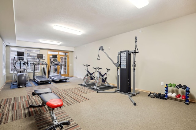 workout area featuring carpet floors and a textured ceiling