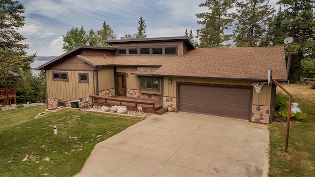 view of front of property featuring a garage and a front lawn