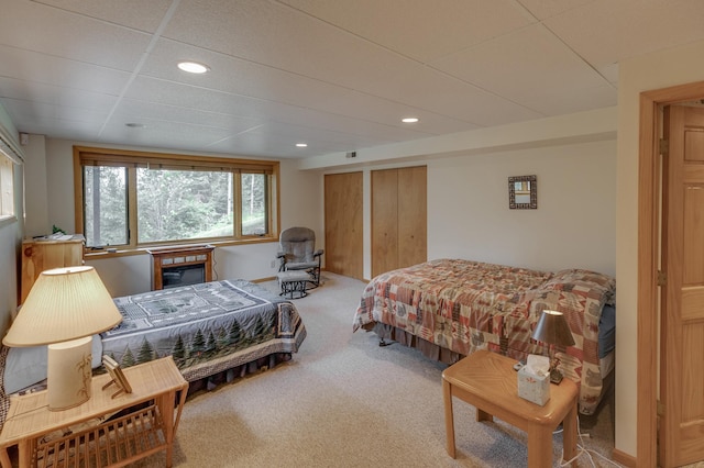 carpeted bedroom featuring a paneled ceiling