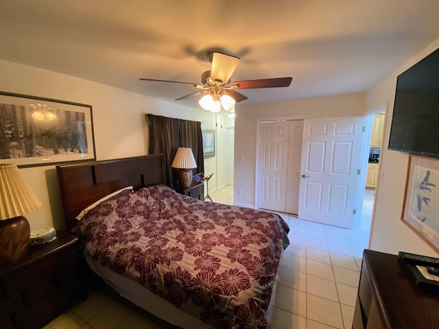bedroom featuring light tile patterned floors, a closet, and a ceiling fan