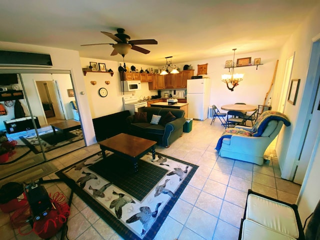 living area with light tile patterned flooring and ceiling fan with notable chandelier
