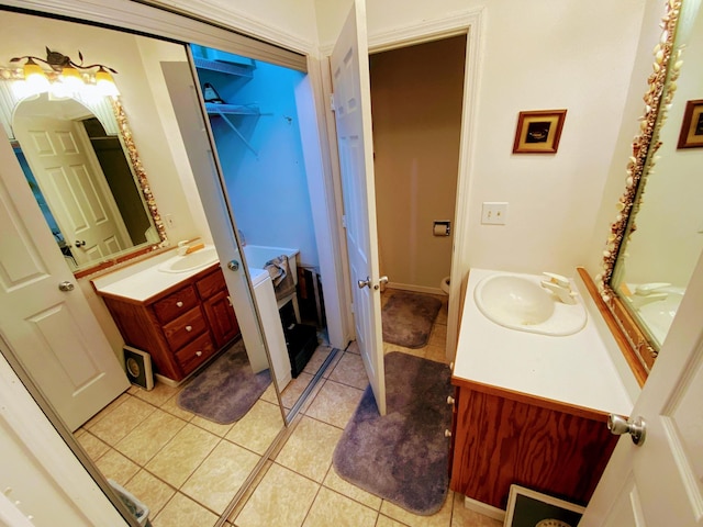 bathroom with tile patterned flooring, vanity, and french doors