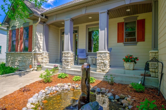 view of exterior entry with covered porch