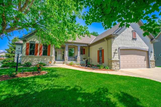 view of front of property with a porch, a front yard, and a garage