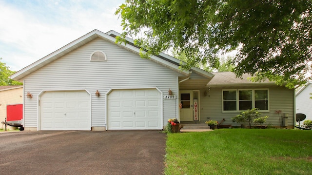 ranch-style house featuring a front yard and a garage