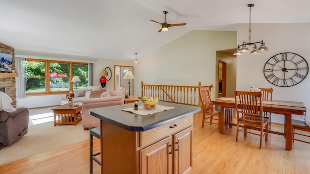 kitchen featuring light hardwood / wood-style floors, lofted ceiling, a kitchen bar, and a kitchen island