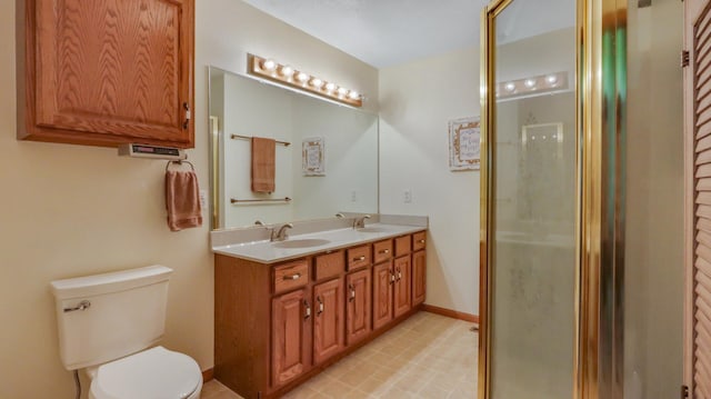 bathroom with vanity, toilet, and an enclosed shower