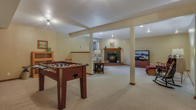 rec room with light carpet and a premium fireplace