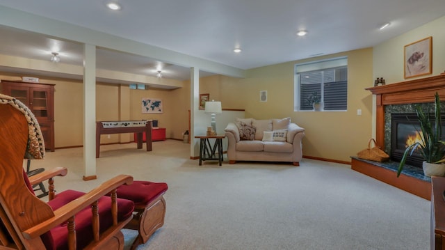 living room featuring light colored carpet and a high end fireplace