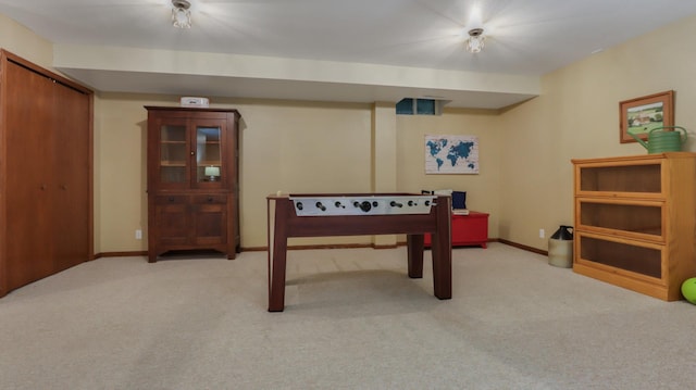 game room featuring light carpet