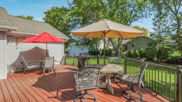 wooden terrace with a lawn