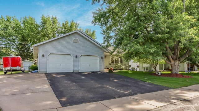 view of front of property with a front yard and a garage