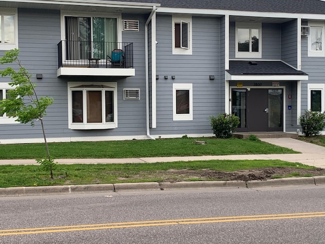 exterior space with roof with shingles