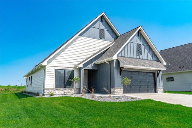 view of front of home with a garage and a front lawn