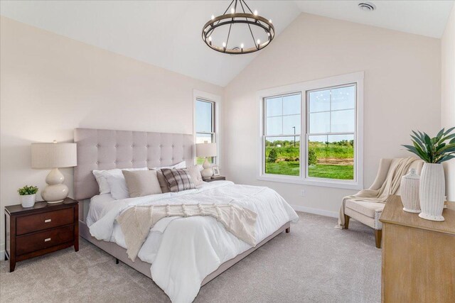 carpeted bedroom with an inviting chandelier and lofted ceiling