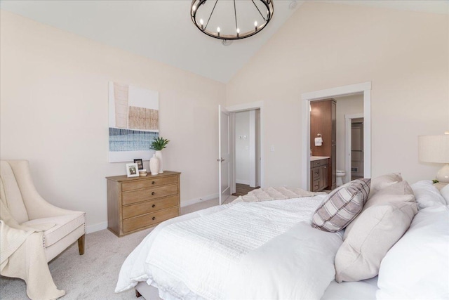 bedroom featuring carpet floors, high vaulted ceiling, connected bathroom, and a notable chandelier