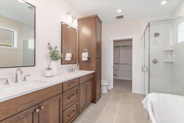 full bathroom featuring a healthy amount of sunlight, tile patterned floors, toilet, and dual bowl vanity