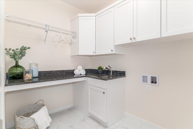 washroom featuring sink, cabinets, hookup for a washing machine, and light tile patterned floors