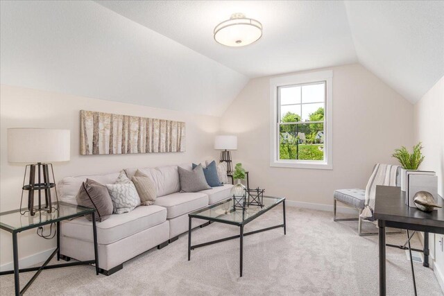 carpeted living room with lofted ceiling