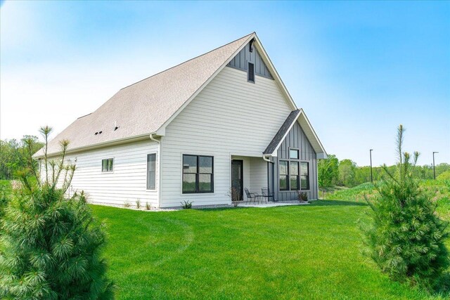 rear view of house featuring a yard