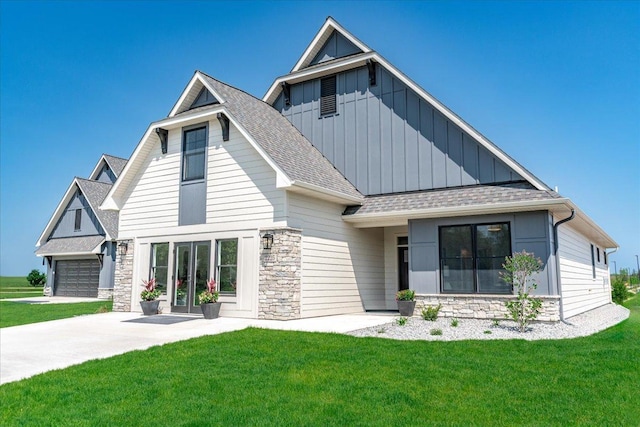 view of front of property with a garage and a front lawn