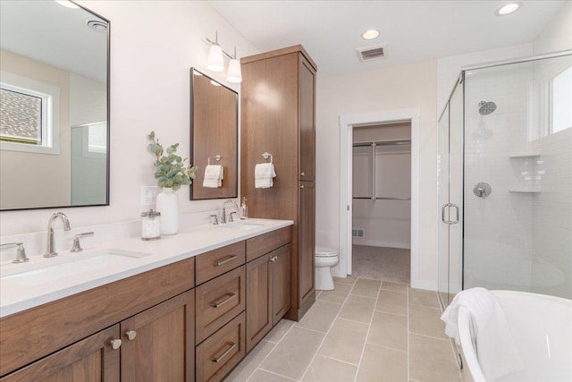 full bathroom featuring tile patterned flooring, vanity, shower with separate bathtub, and toilet