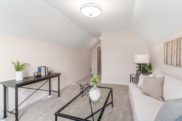 carpeted living room with vaulted ceiling