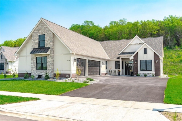 view of front of house with a garage and a front yard