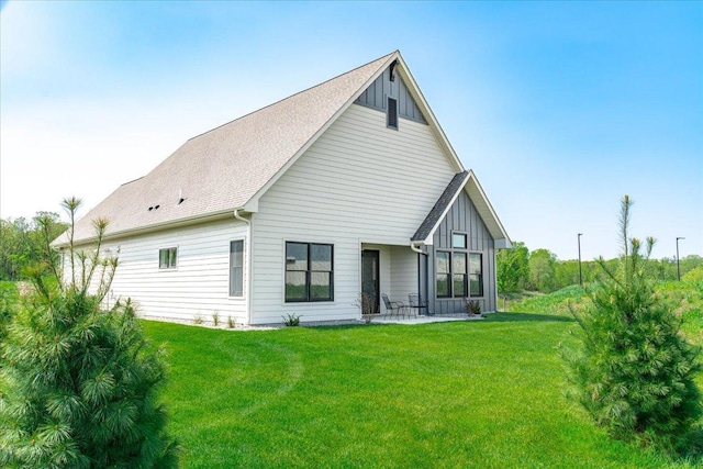 rear view of house featuring a yard