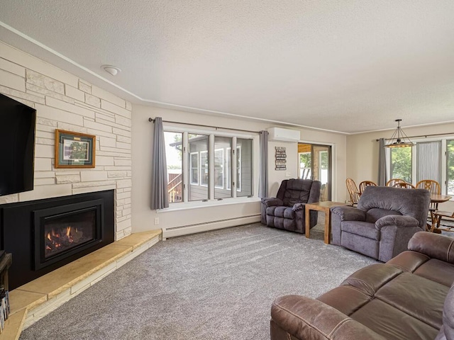 carpeted living area featuring a baseboard radiator, a textured ceiling, a stone fireplace, a wall mounted air conditioner, and crown molding
