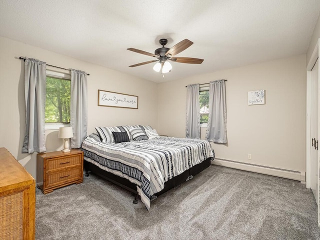 bedroom featuring a baseboard heating unit, carpet, and ceiling fan