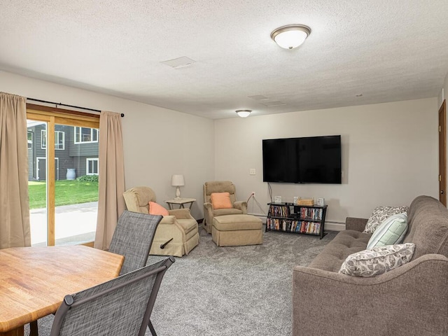 living area featuring carpet, a textured ceiling, and a baseboard radiator