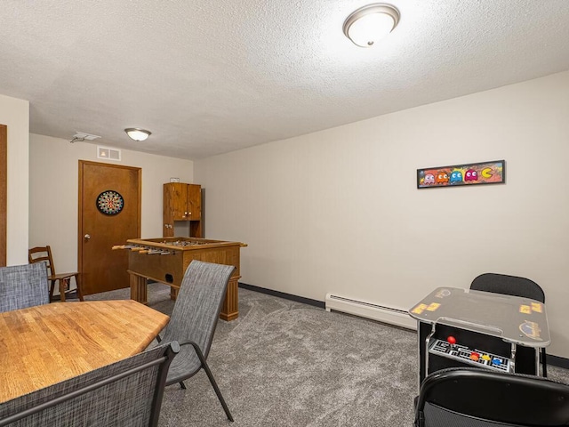 carpeted office space featuring a baseboard radiator, a textured ceiling, and baseboards