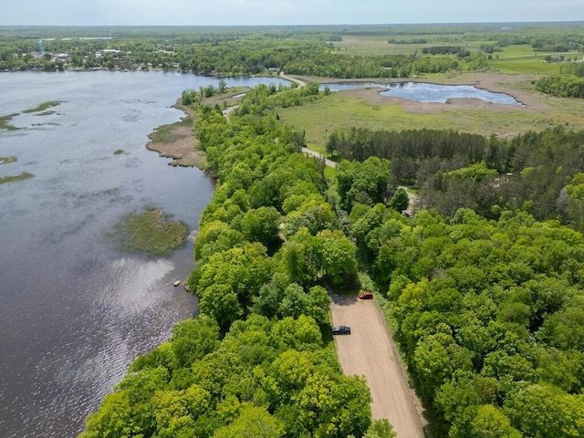 aerial view of a nearby body of water and a heavily wooded area