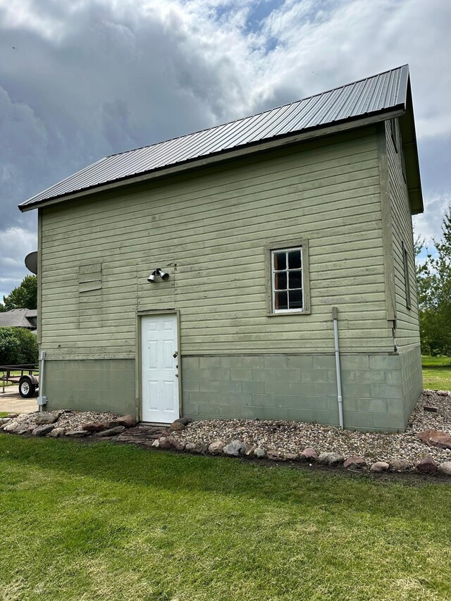 view of side of home with a lawn