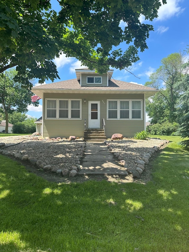 back of house with a lawn