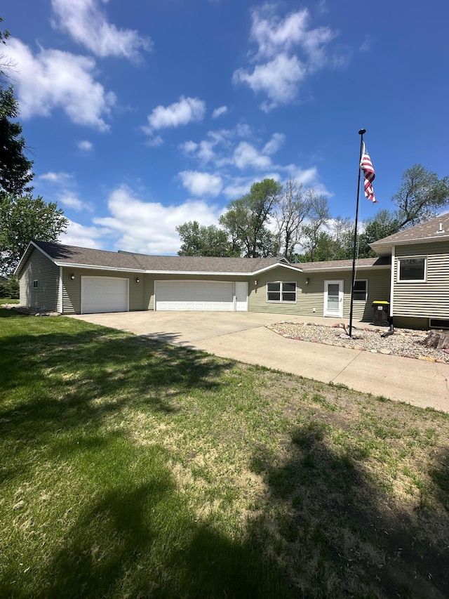 back of property with a garage and a yard