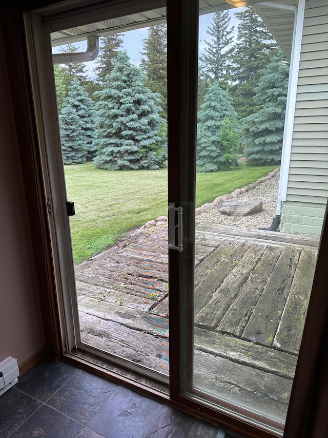 921 11th St N, Mountain Lake, MN 56159 - doorway featuring baseboards, a baseboard heating unit, and stone tile flooring