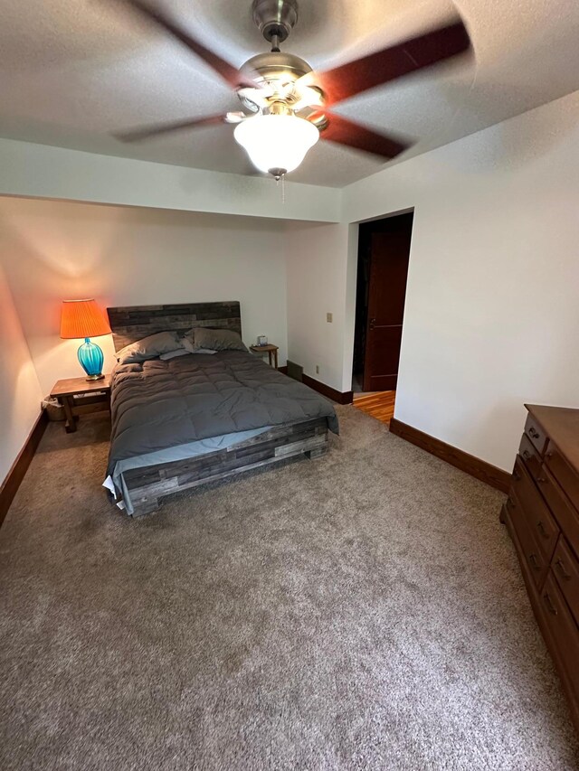 unfurnished bedroom featuring ceiling fan, a textured ceiling, and carpet flooring