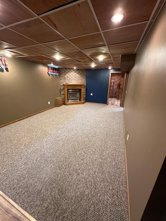 basement featuring carpet floors and a brick fireplace