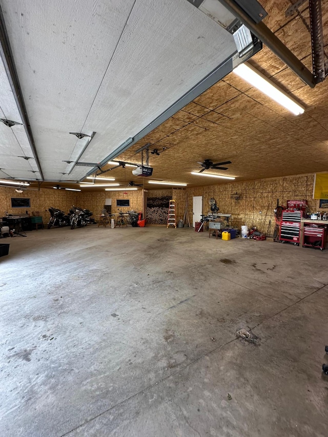 garage with ceiling fan and a garage door opener