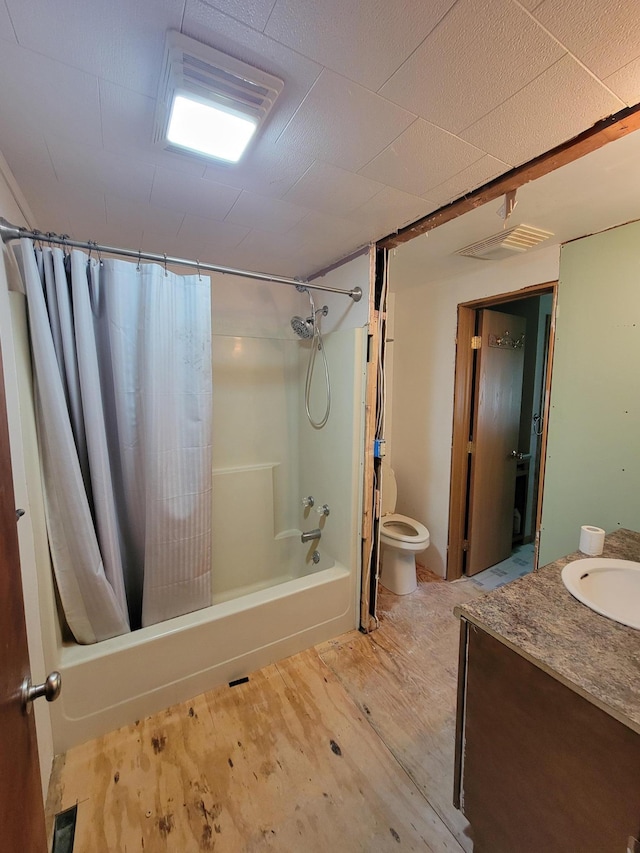 full bathroom featuring hardwood / wood-style floors, toilet, vanity, and shower / tub combo with curtain