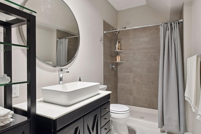 bathroom featuring a shower with curtain, vanity, and toilet