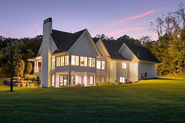 back house at dusk with a yard