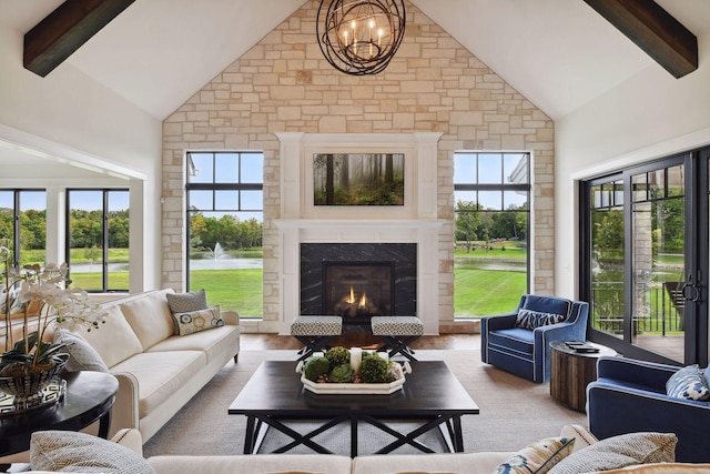 living room with beamed ceiling, high vaulted ceiling, and a wealth of natural light