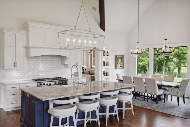 kitchen featuring high vaulted ceiling, white cabinetry, and dark wood-type flooring