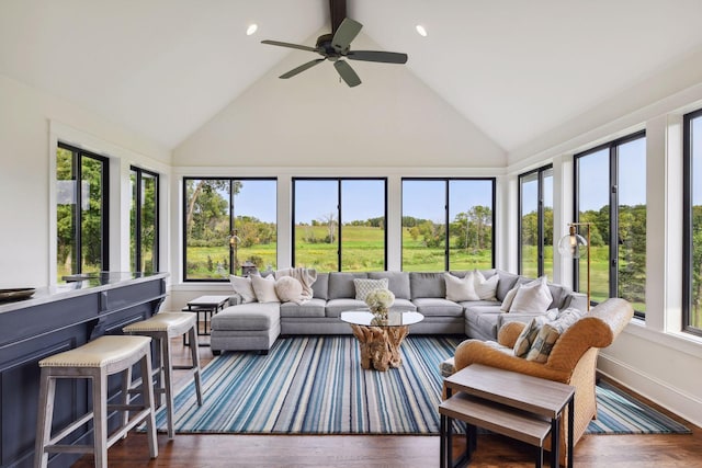 sunroom with plenty of natural light, lofted ceiling, and ceiling fan