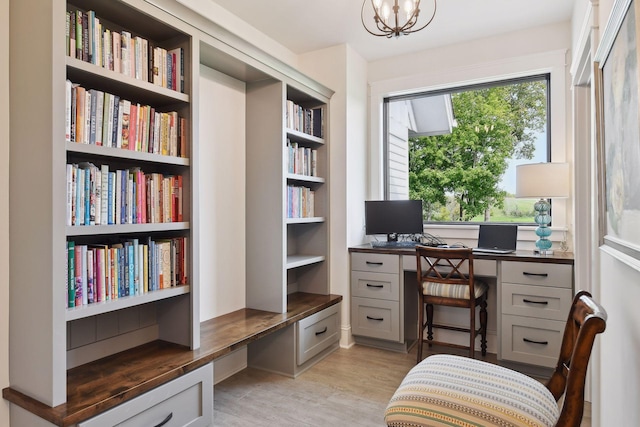 office space with light hardwood / wood-style floors and an inviting chandelier