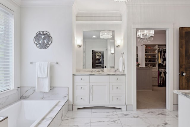 bathroom featuring vanity, tiled bath, an inviting chandelier, and crown molding